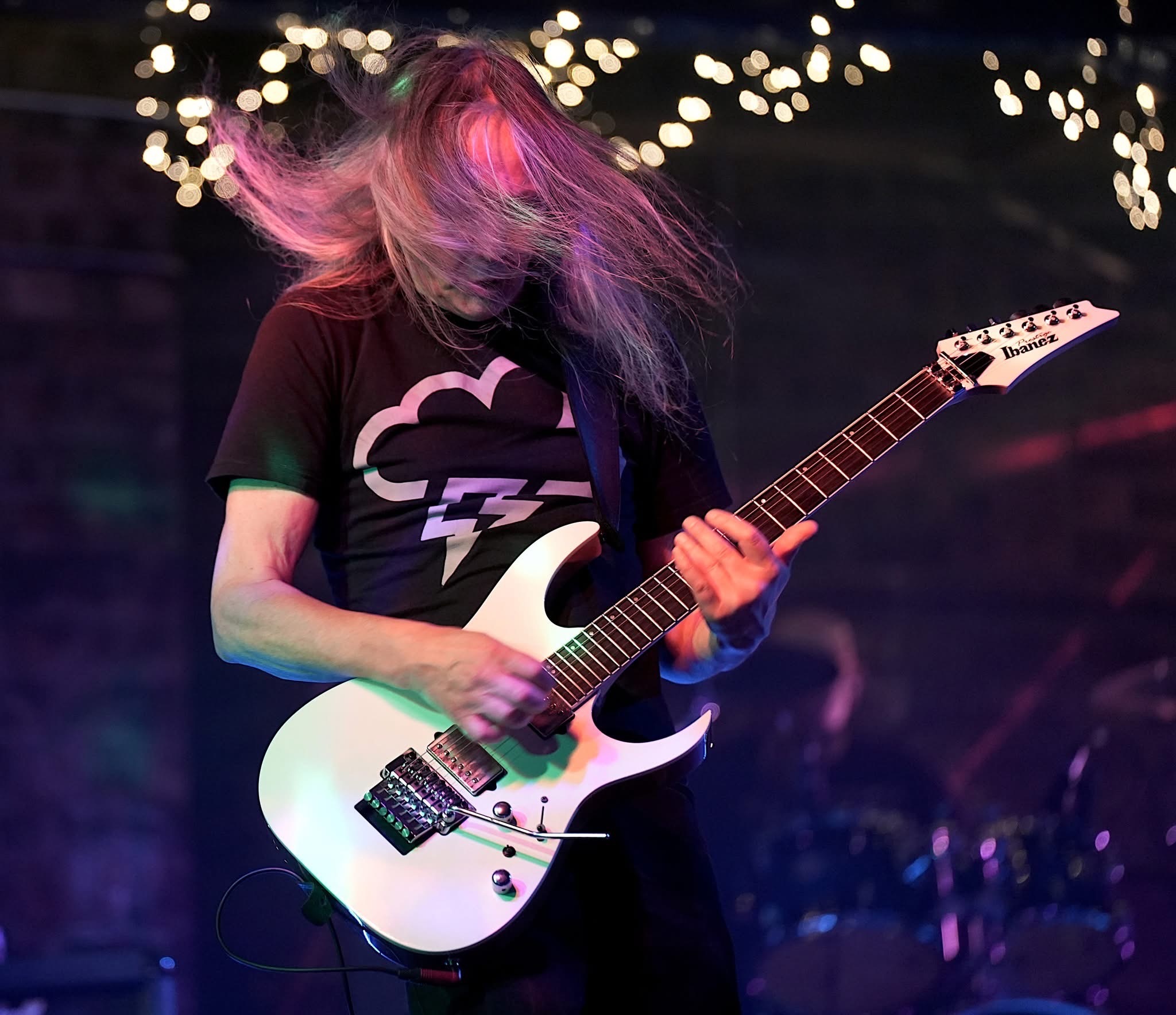 Jim on lead guitar mid-headbang, magenta and violet stage wash, Mike Breen Band live at Whistle Binkies Edinburgh